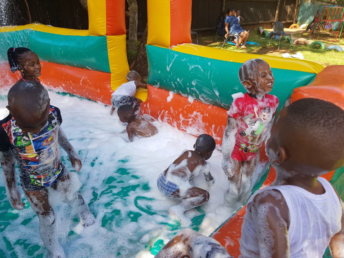 Children splashing in the foam inside the inflatable pit