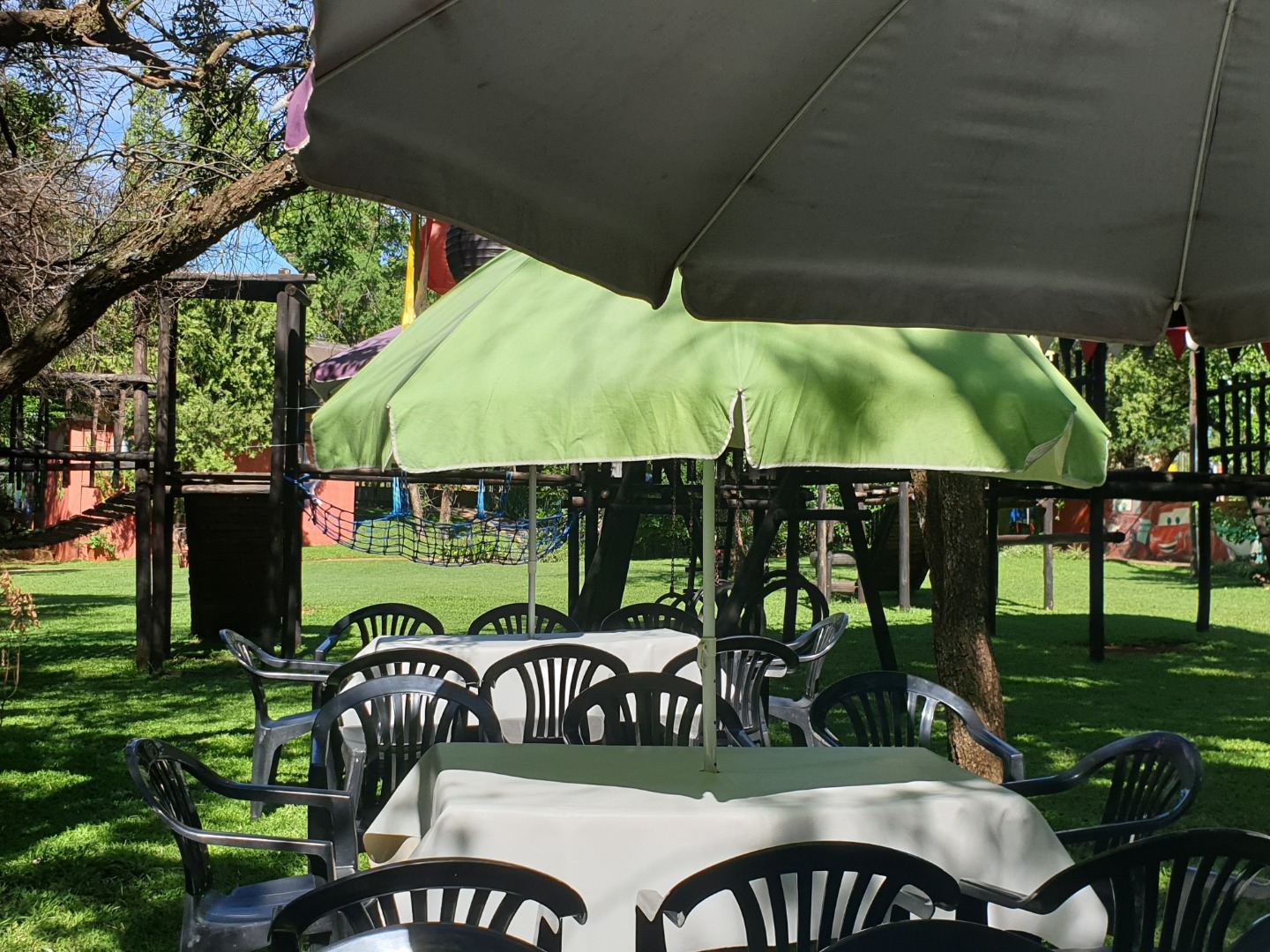 Shaded seating under a gazebo beside the play area