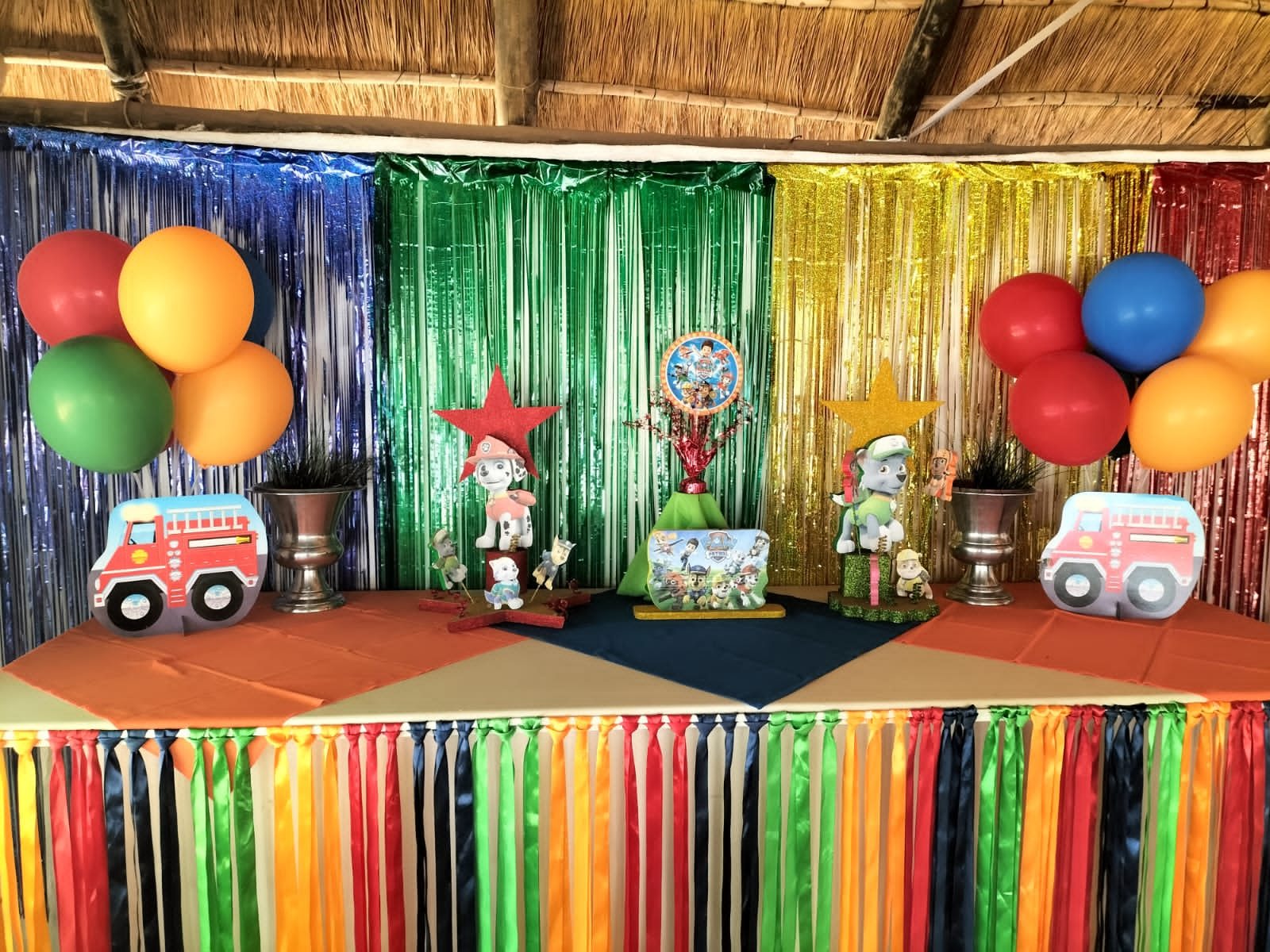 Rainbow fringe backdrop and dressed table for a children&rsquo;s party