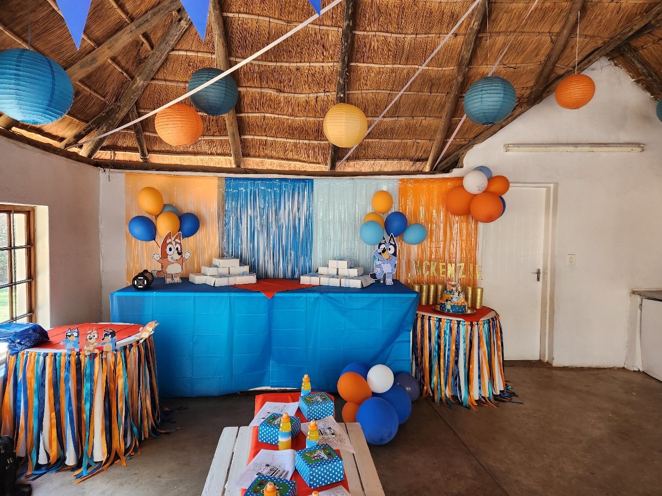 Blue and orange table setting with hanging lanterns
