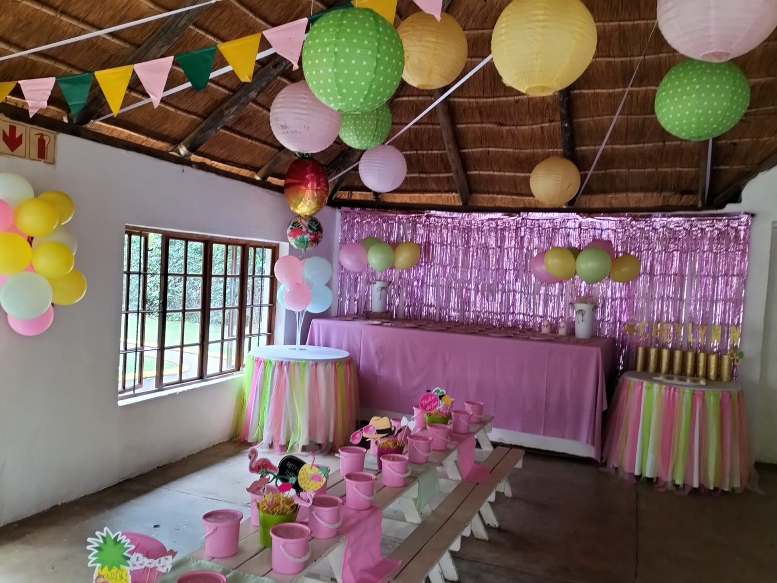 Pink themed tables and benches ready for guests
