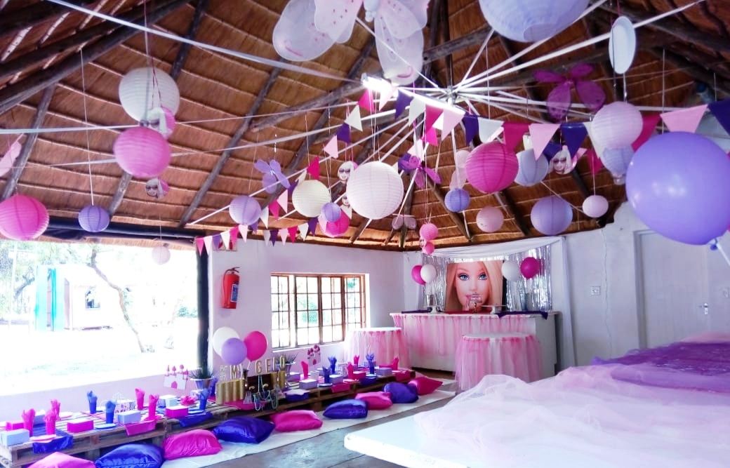 Pink and white themed setting with lanterns and low tables