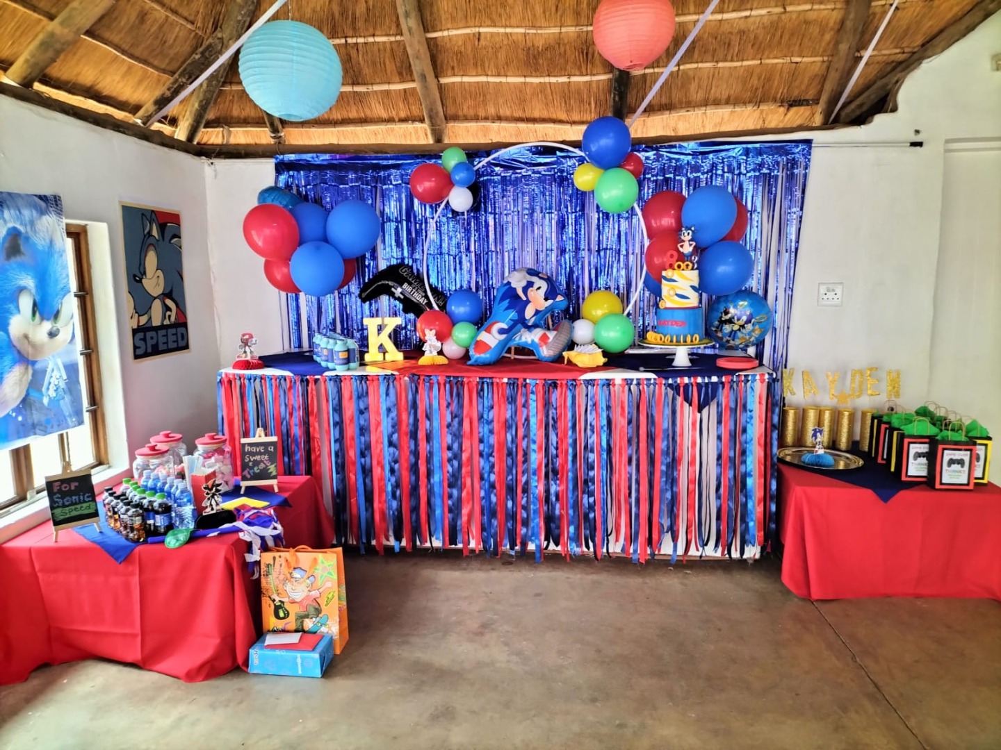 Blue and red character theme with balloons and a gift table