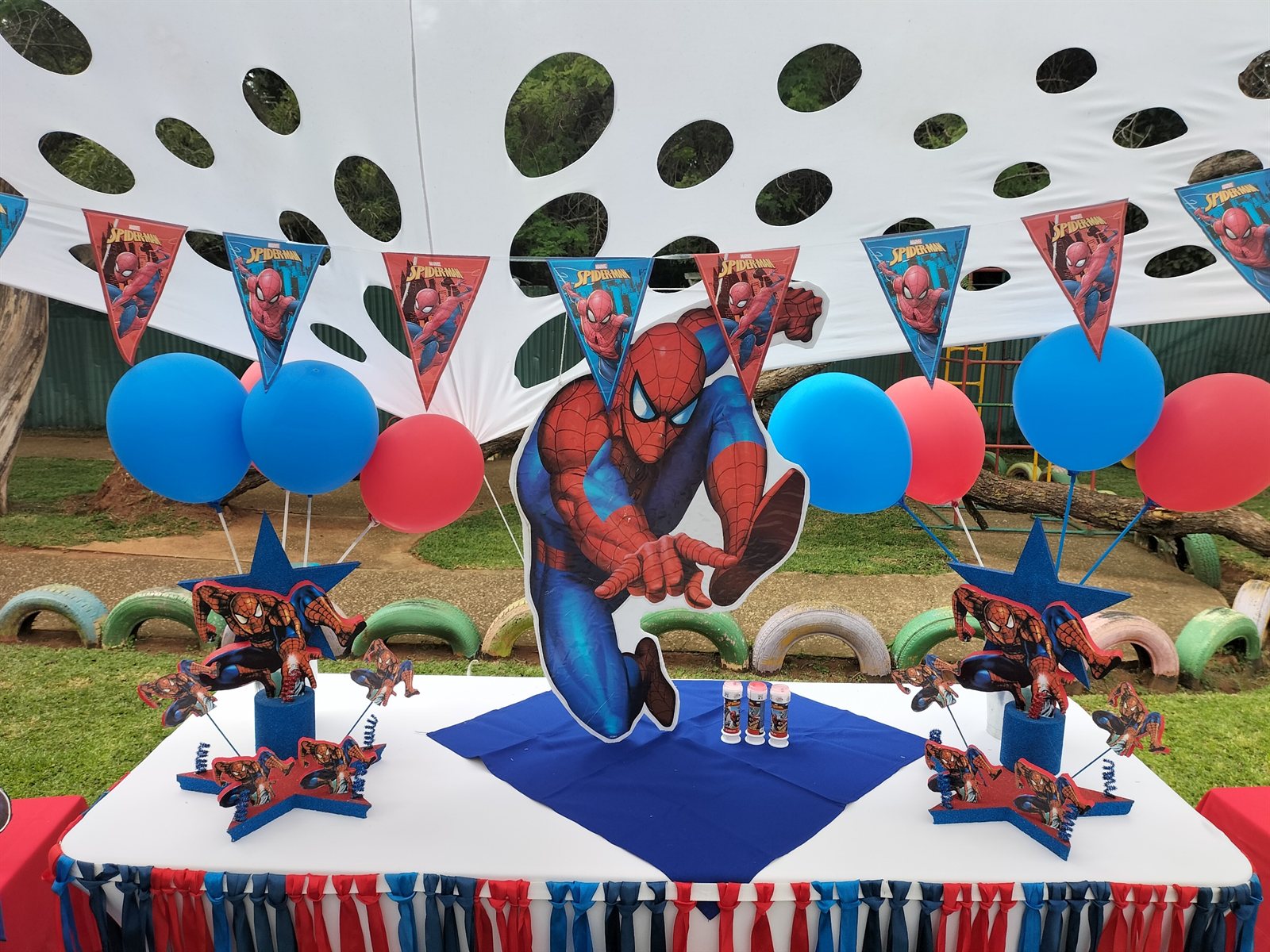 Spiderman themed table setting under the stretch tent