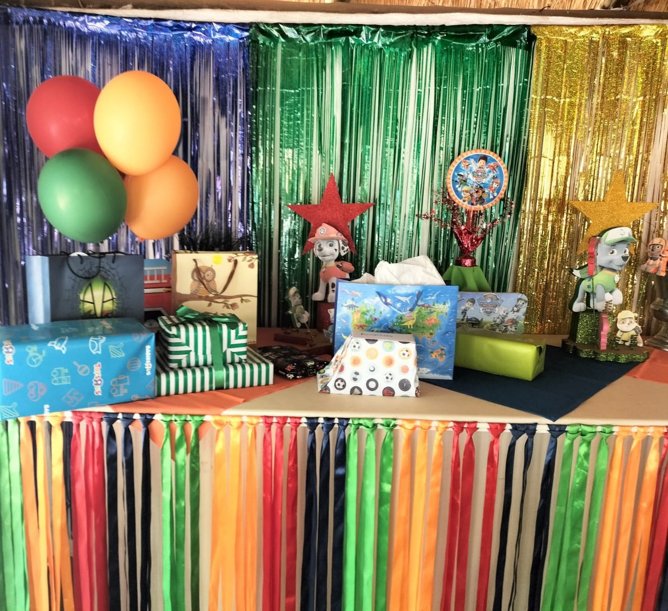 Christmas themed table with gifts and foil fringe