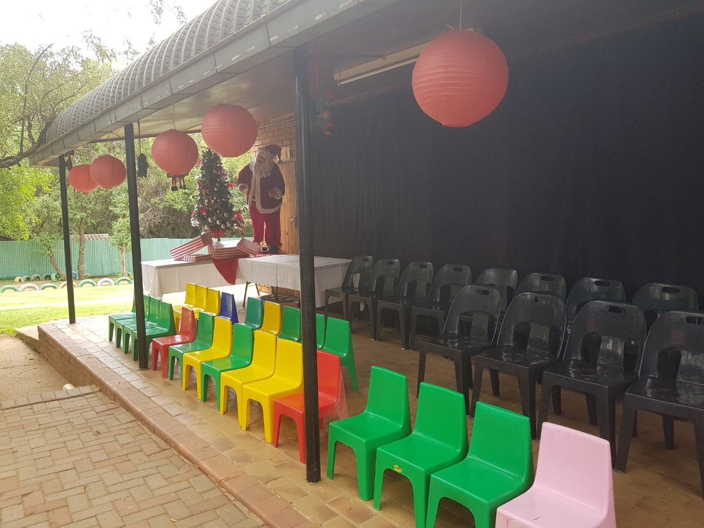 Rows of colourful chairs set out facing the stage for a graduation