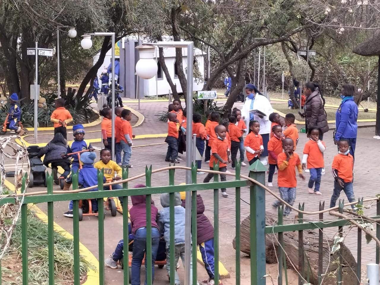 A large group of learners walking through the estate