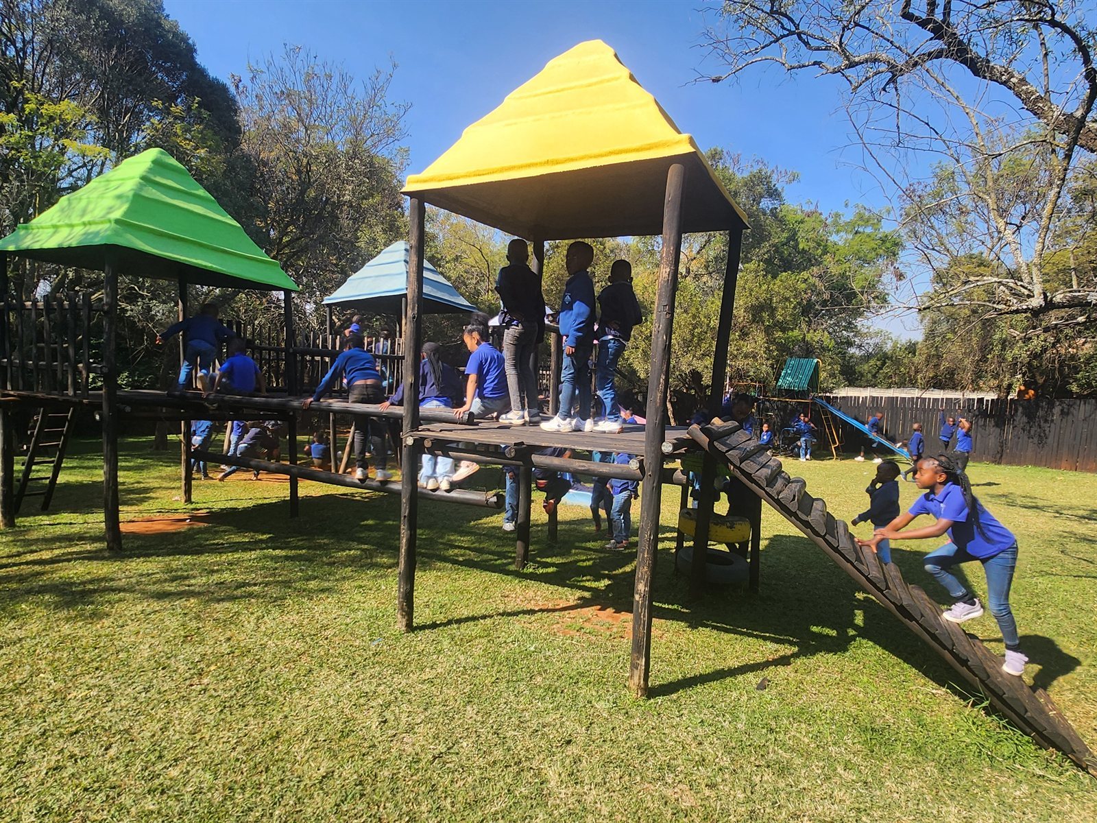 Play frames and picnic tables set out for a school group
