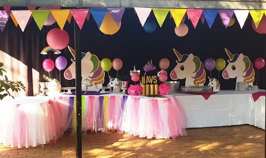 Unicorn-themed kids birthday party with tulle table skirts