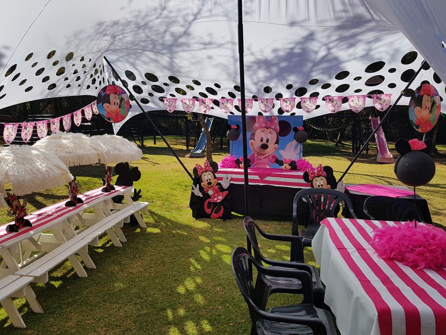 Black and white stretch tent decorated for a party on the lawn