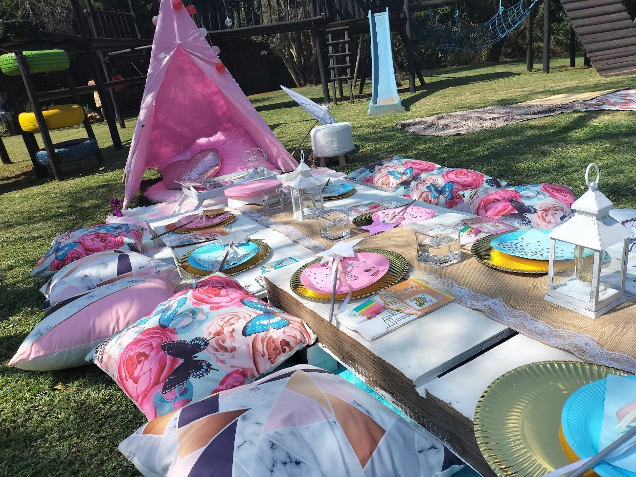 Children&rsquo;s table setting with teepees and place settings on the grass